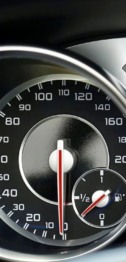 Close-up of a sleek car speedometer with glossy finish and chrome details.