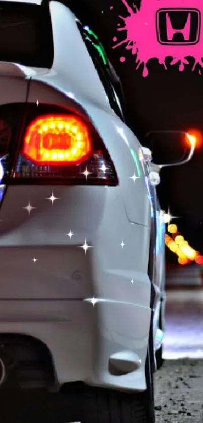 Sleek white car with pink logo in city lights.