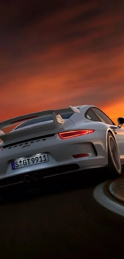 Sports car speeding into sunset on a winding road.