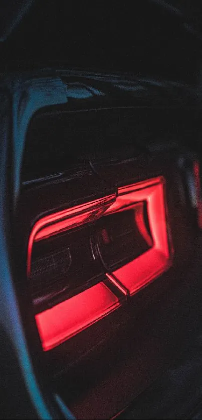 Vibrant red car tail light in dark setting.