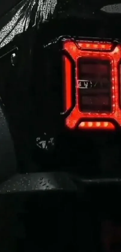 Car tail light glowing in wet and dark environment.