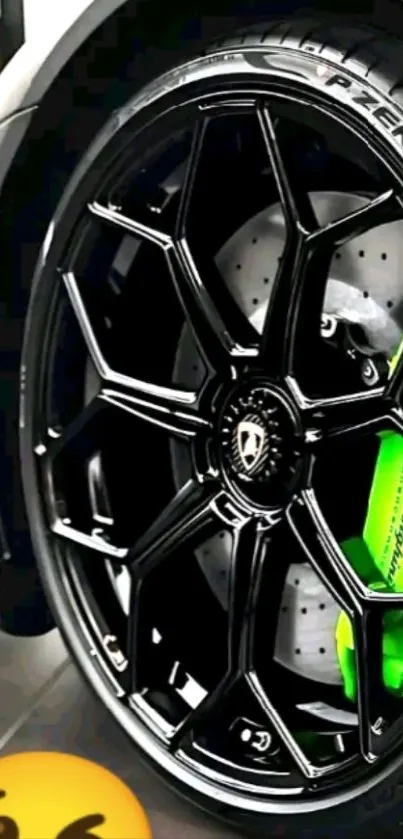 Close-up of a car wheel with a black rim and green brake caliper.