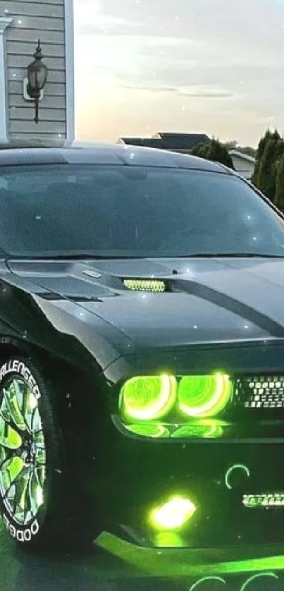 Black car with neon green lights parked on driveway at dusk.