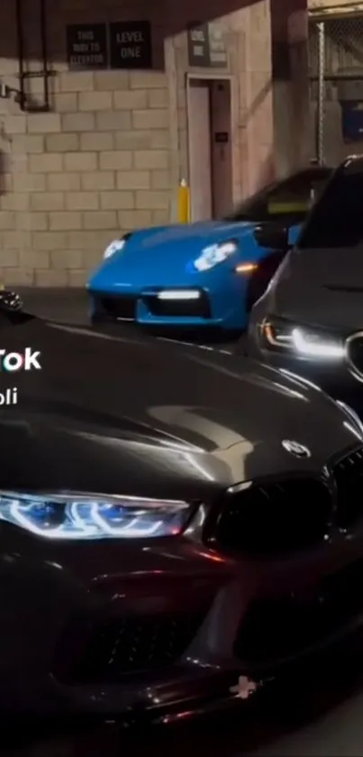 Luxury cars parked in a dimly lit urban alley at night.