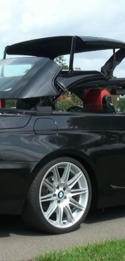 Sleek black convertible car with a retractable top and elegant design.