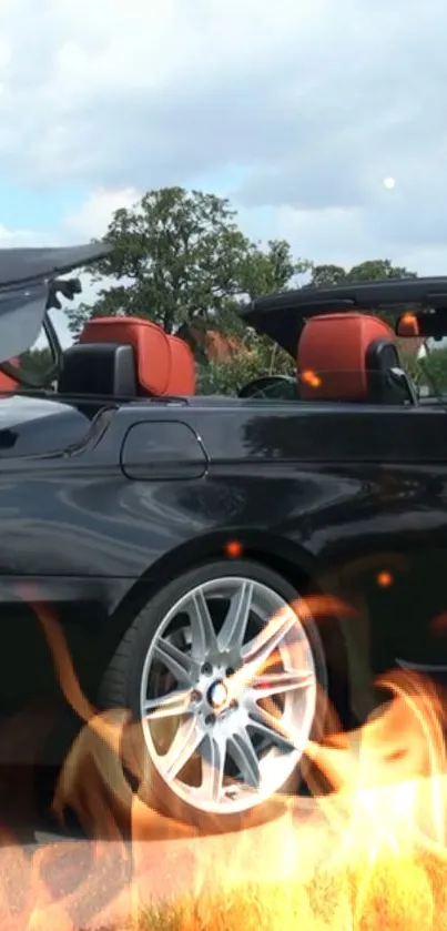 Black convertible car with flame background.