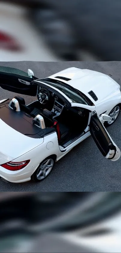 White convertible car with open doors, viewed from above.