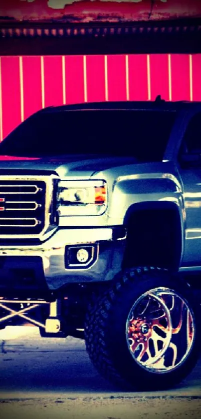 Lifted custom truck with red backdrop.