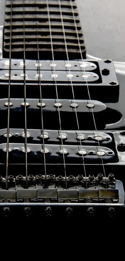 Close-up of a sleek black electric guitar with glossy finish.