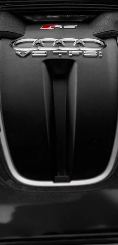 Close-up view of a sleek engine design with intricate automotive details in black.