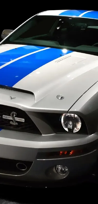 Ford Mustang with blue racing stripes on black background.