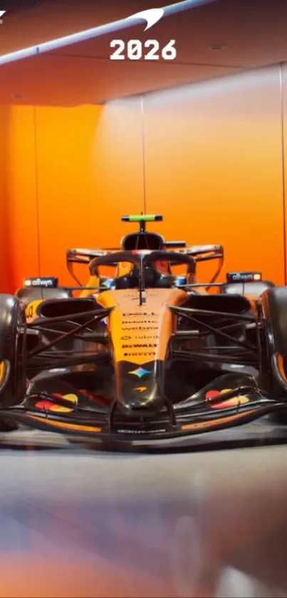 Sleek Formula race car with orange backdrop.