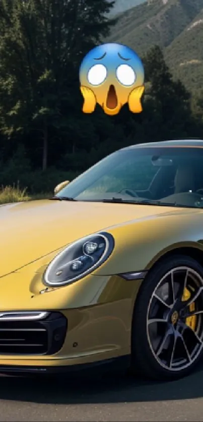 Gold sports car with shocked emoji on scenic road.