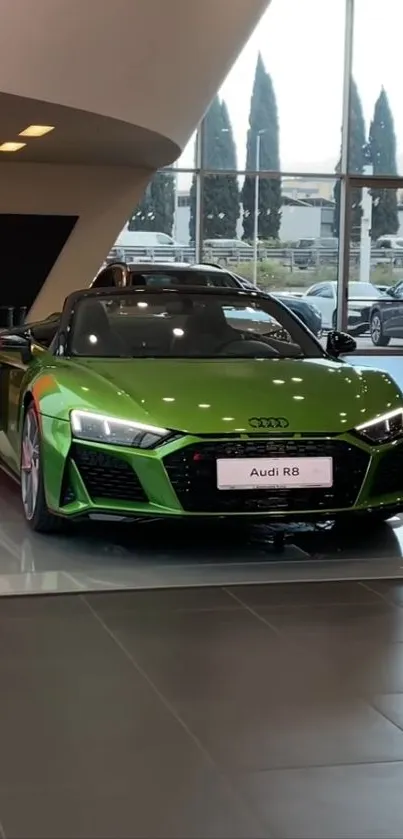 Green Audi R8 in a dealership showroom.