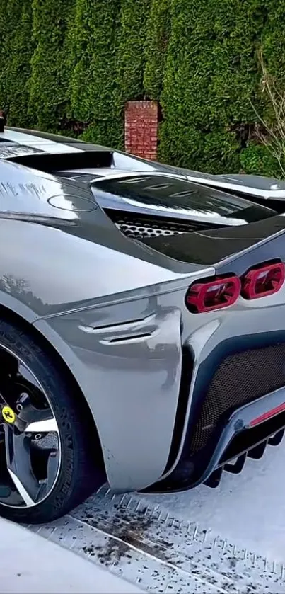 Silver sports car with sleek design parked outdoors.