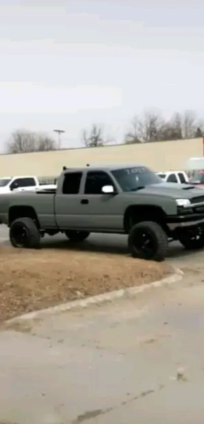 Grey pickup truck in urban parking lot setting.