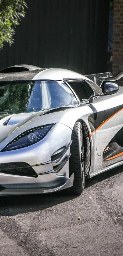 Sleek silver hypercar parked in an urban setting, showcasing futuristic design.