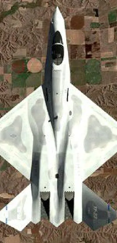 A sleek white jet flying over a desert landscape capturing a top-down view.