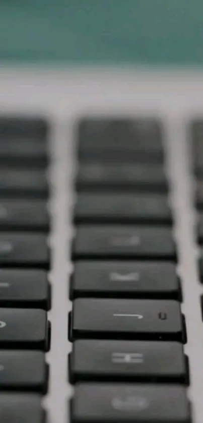 Close-up of a sleek black keyboard with a blurred background.