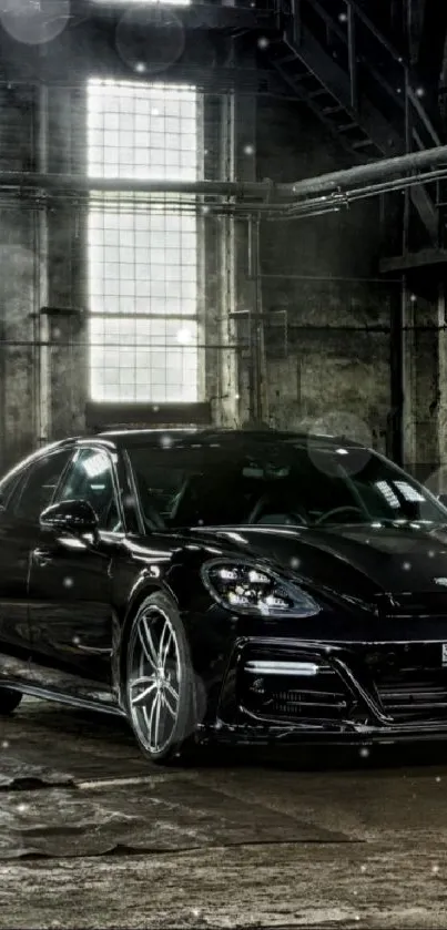 Sleek black car in an industrial setting wallpaper.