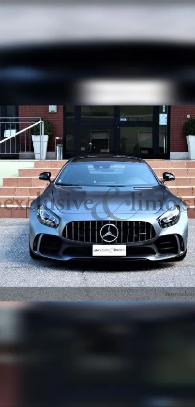 Black luxury sports car front view in urban setting.