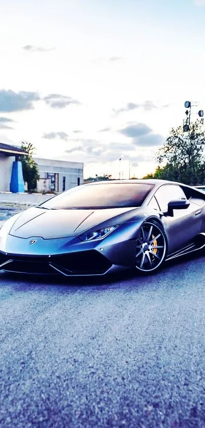 Sleek sports car on a scenic road with a blue sky backdrop.