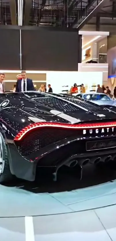 Sleek black Bugatti luxury car showcased at an exhibition.