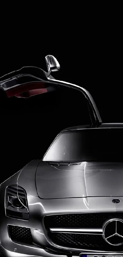 Sleek metallic sports car with gullwing door against black background.