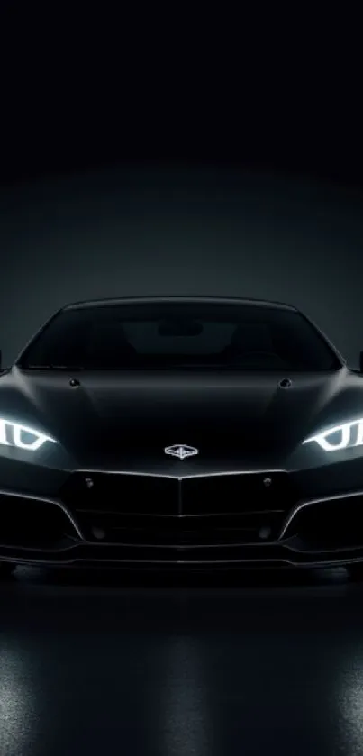 Black sports car with glowing headlights in the dark.