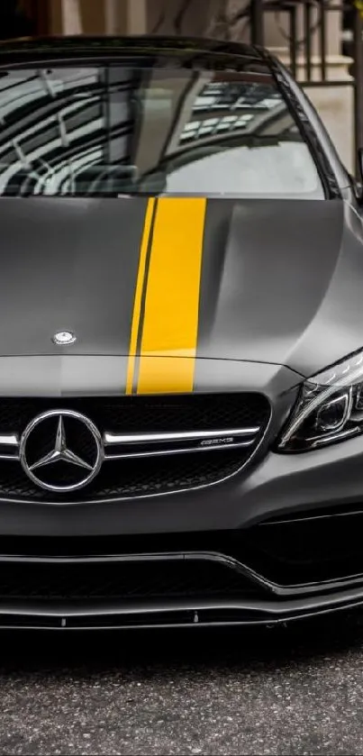 Sleek Mercedes car with yellow stripe on an urban background.