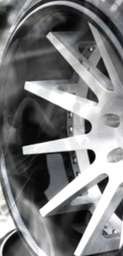 Close-up view of a modern car wheel with a sleek, polished metal design.