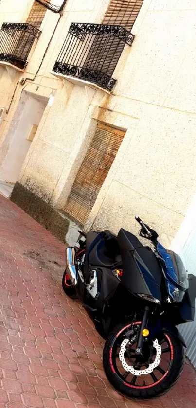 Black motorcycle parked by a beige building.