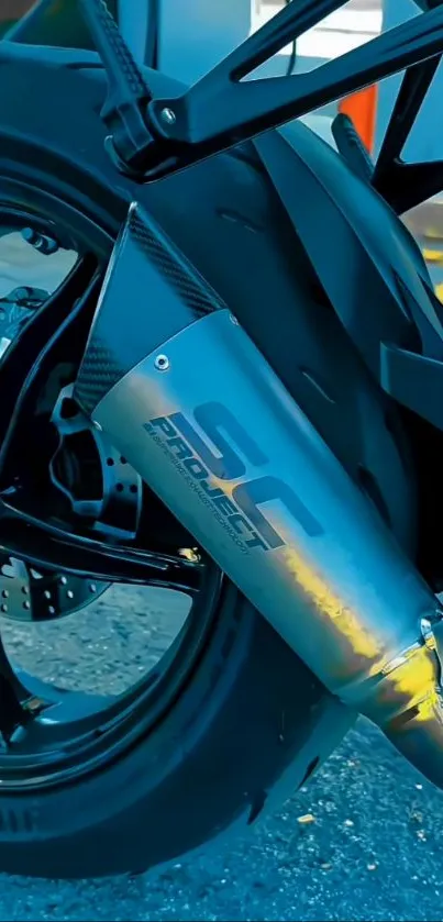 Close-up of a motorbike's rear wheel and exhaust pipe with modern design.