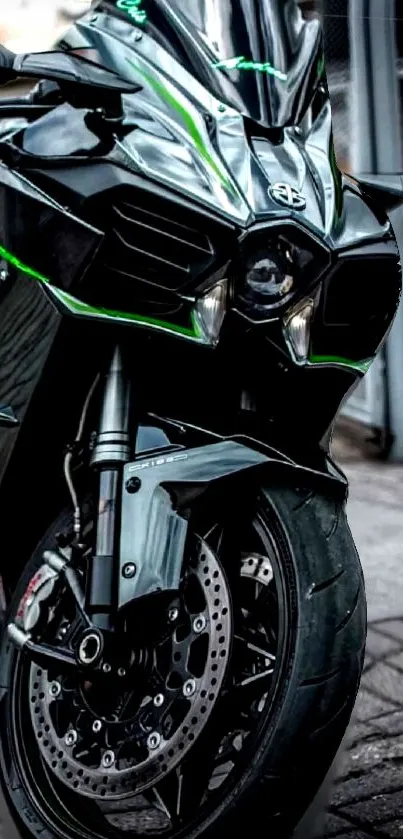 Front view of a sleek black motorcycle with green accents on a tiled floor.