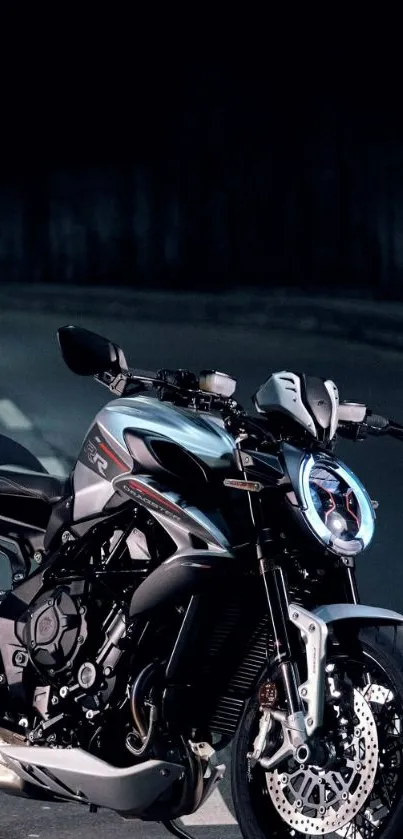 Sleek motorcycle against a dark urban night backdrop.