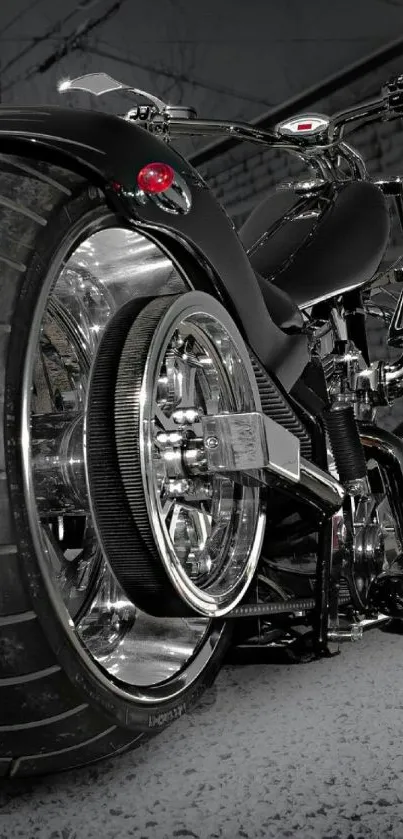 Black motorcycle rear view with chrome details and large tire.