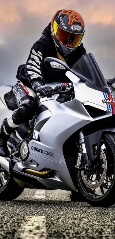 Motorcyclist on a sleek bike under dramatic skies.