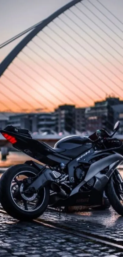 Sleek motorcycle at sunset by urban bridge.