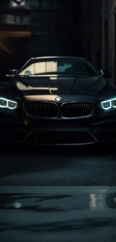 Luxurious black car with headlights in a dark urban setting.