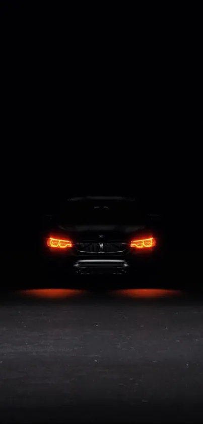 Dark wallpaper with glowing car headlights.