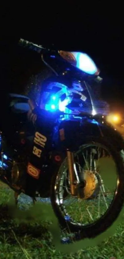 Motorcycle glowing in blue lights at night.