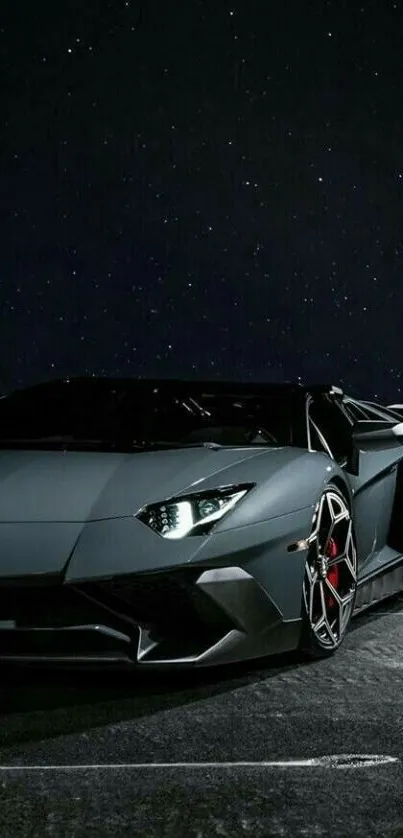 Sleek sports car at night with starry sky backdrop.