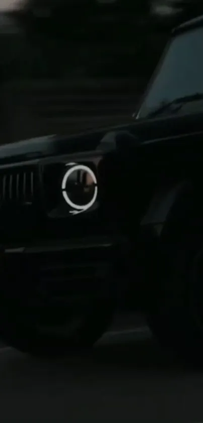 Dark-themed luxury car driving at night, close-up view.