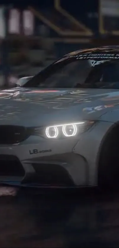 Sleek gray BMW with glowing headlights at night.