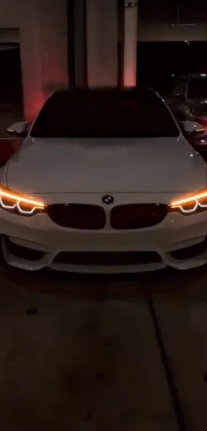 White BMW with glowing headlights in dark garage