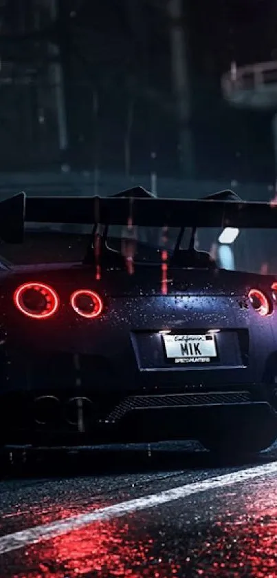 Sleek sports car with glowing taillights at night.