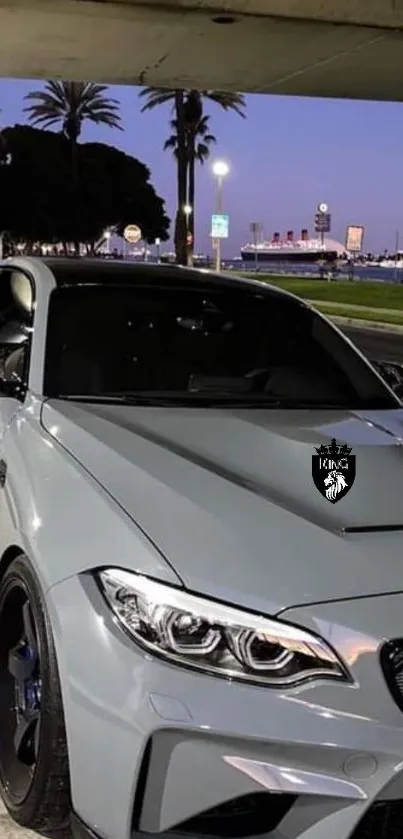 Sleek sports car under city lights at night.