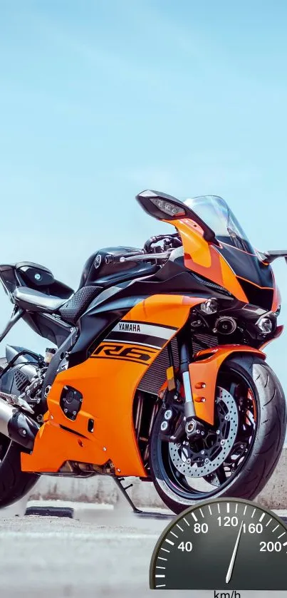 Orange sports motorcycle against clear sky with speedometer overlay.