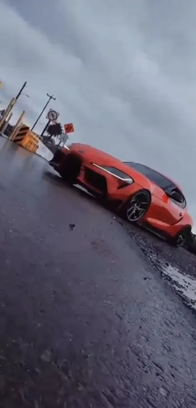 Orange sports car parked on a rainy road.