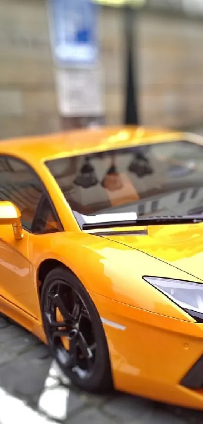 Orange sports car parked on cobblestone street.